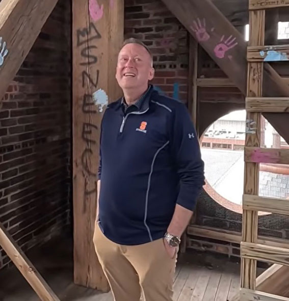 Chancellor Haynie stands inside Crouse College's bell tower 