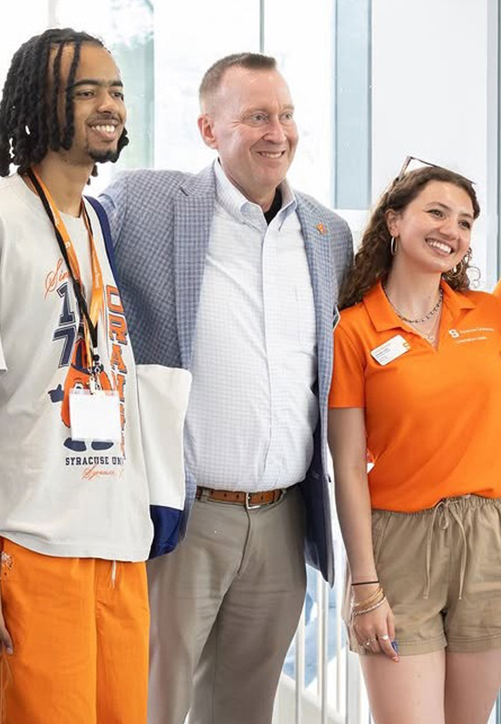 Chancellor Haynie poses with new students indoors.