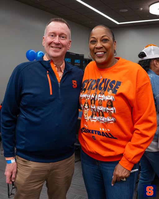 Chancellor Haynie and Coach Felisha Legette-Jack smile for a photo indoors