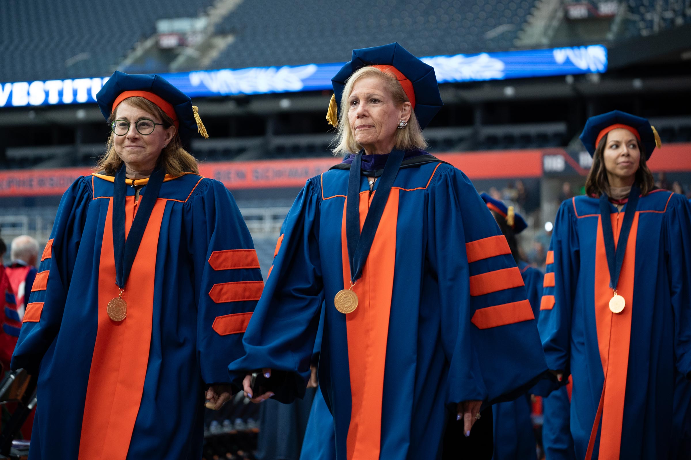Board members dressed in regalia join the procession.