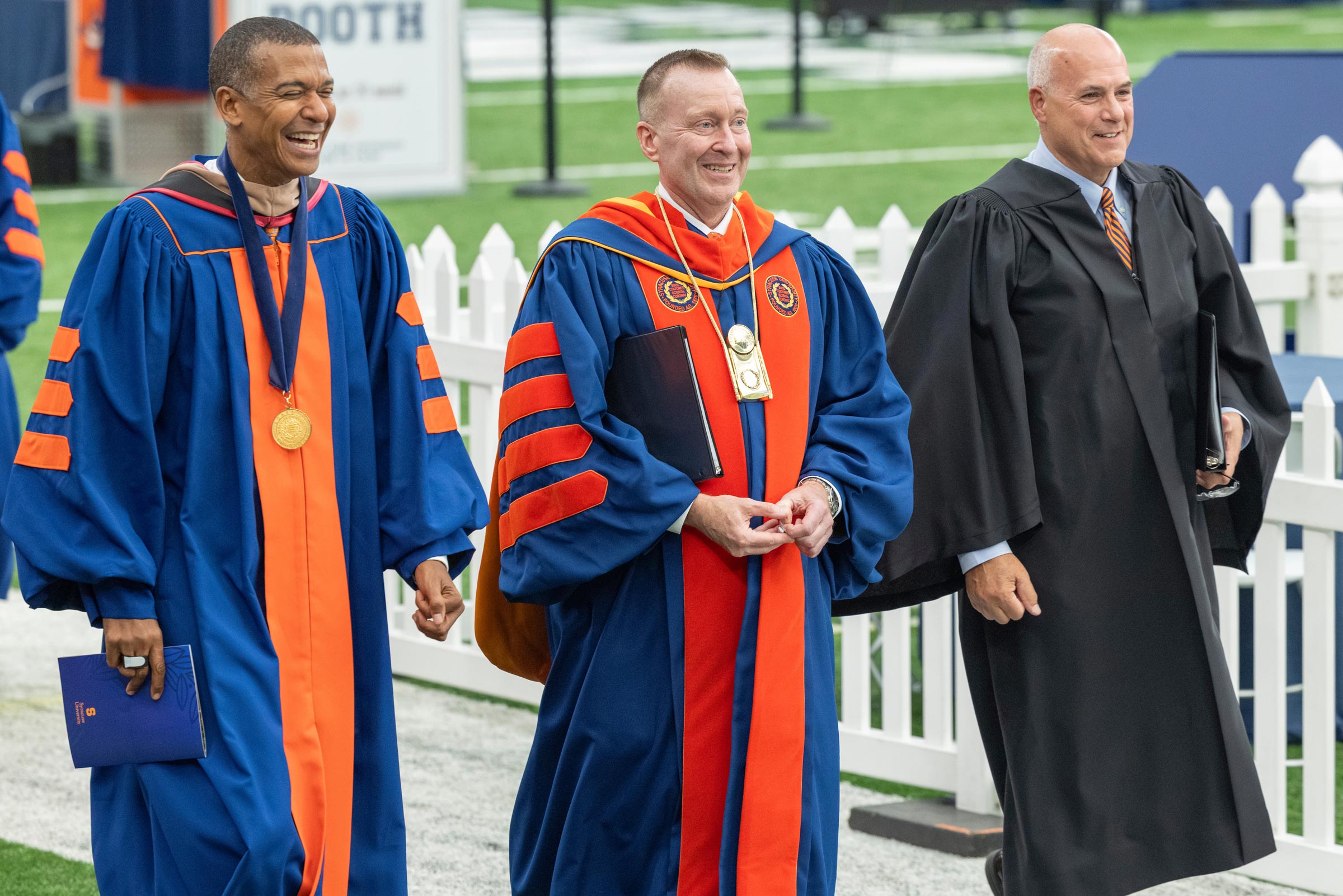 Board Chair Jeff Scruggs, Chancellor Mike Haynie and Pete Sala walk along the field of the stadium as they approach the festivities at the conclusion of the Inauguration.