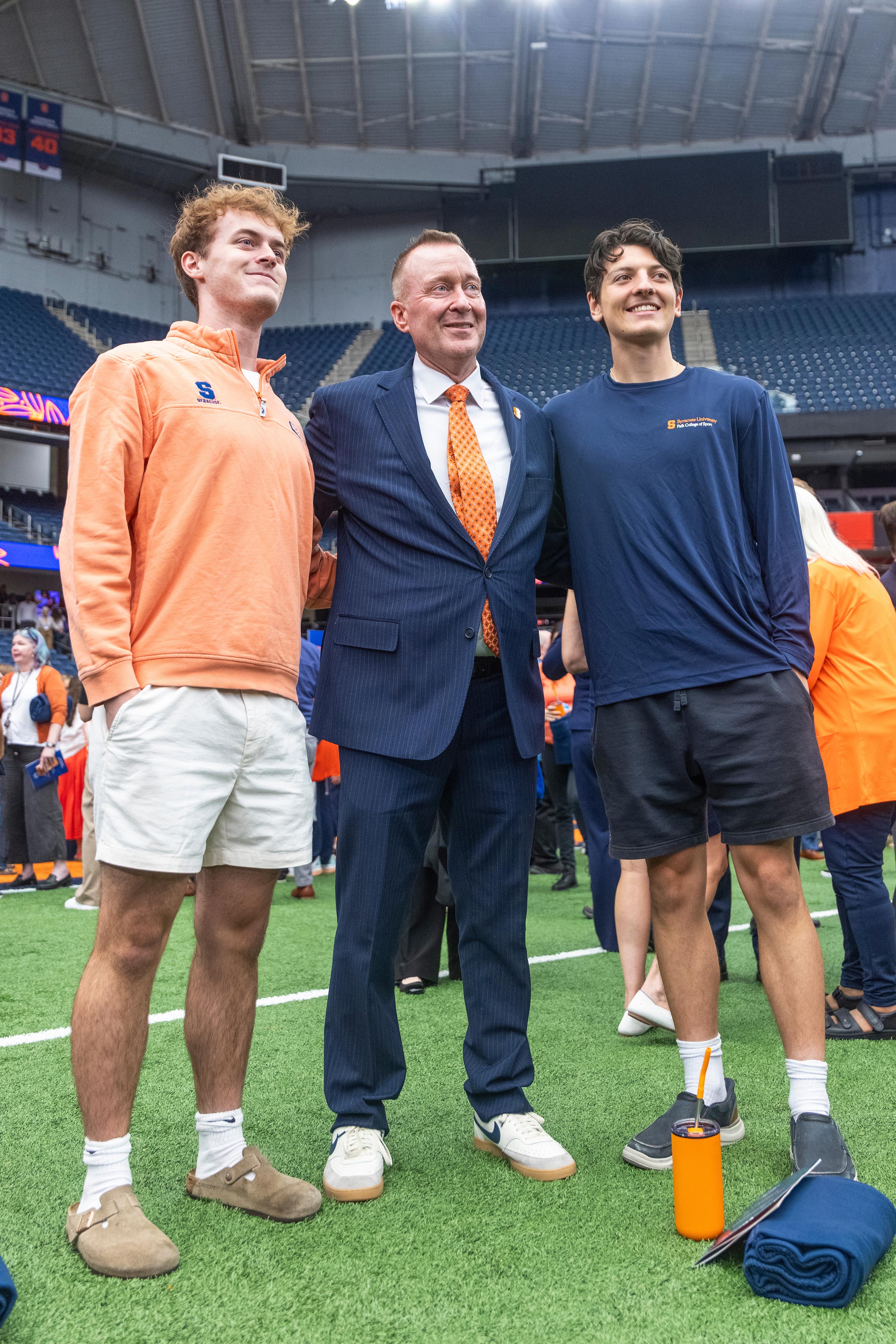 Chancellor Mike Haynie stands between two students for a photo..