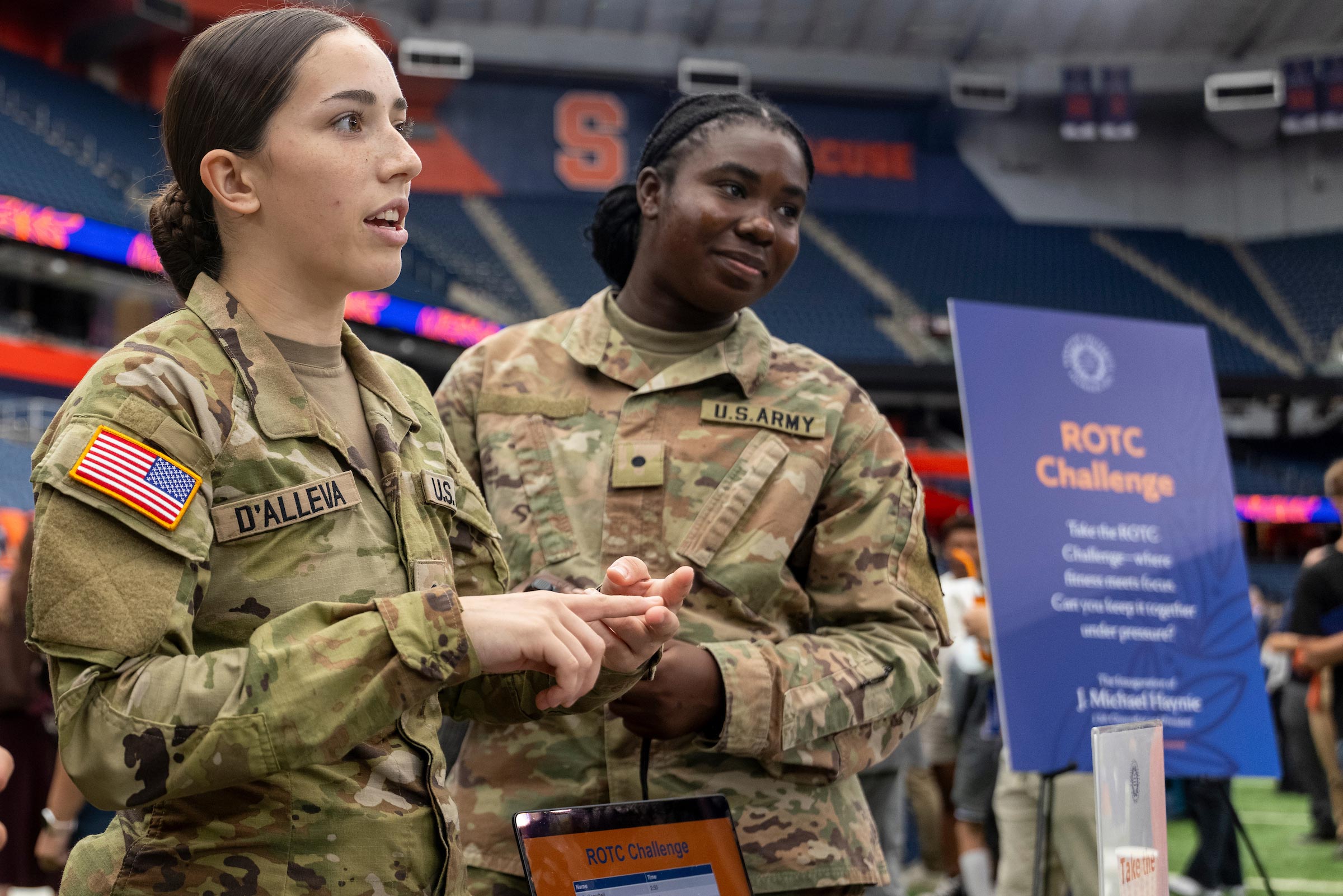 Two ROTC students dressed in their US Army uniforms help out at the ROTC challenge as part of the Orange Fest.