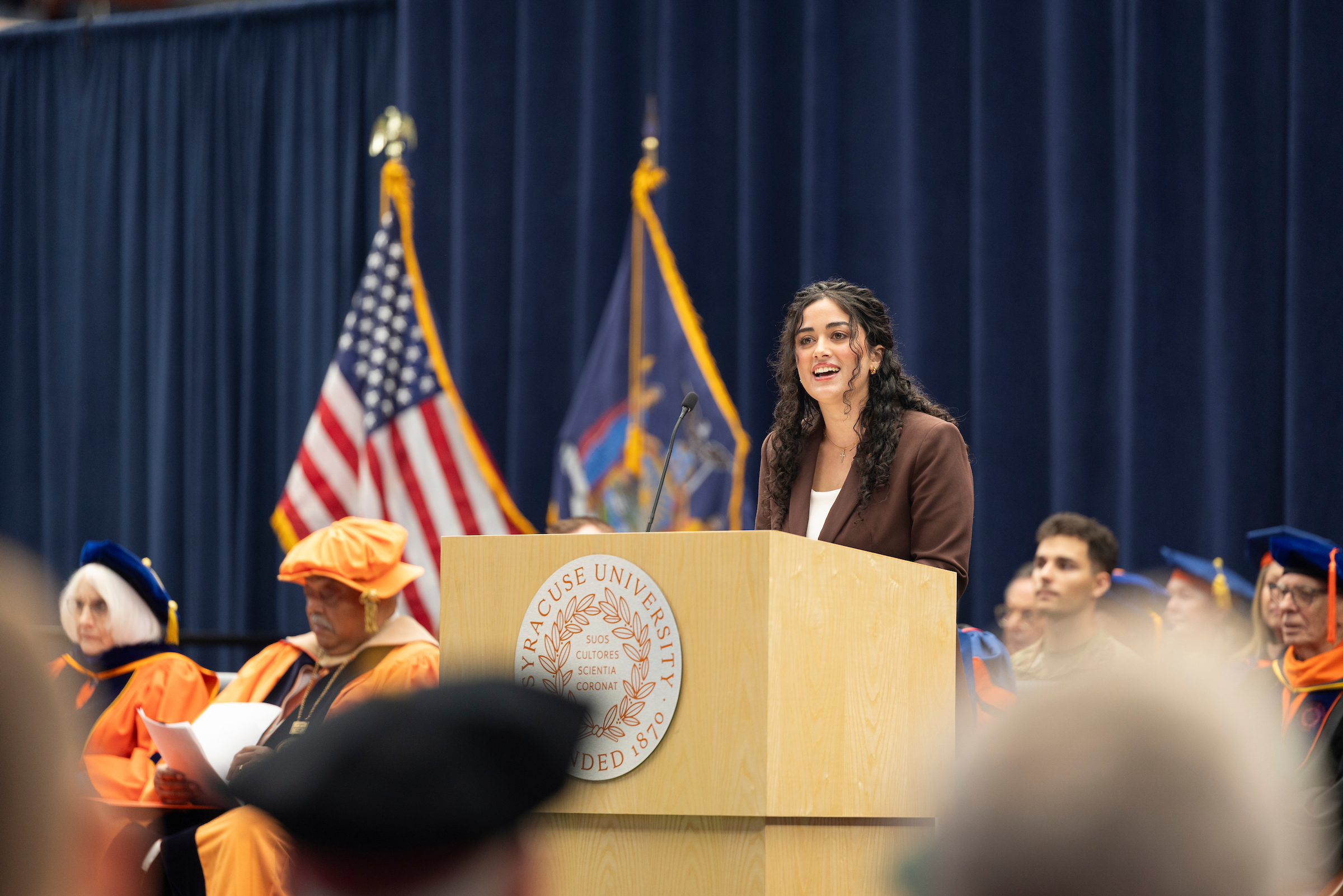 The student body president shares her thoughts from behind the podium during the inauguration ceremony.