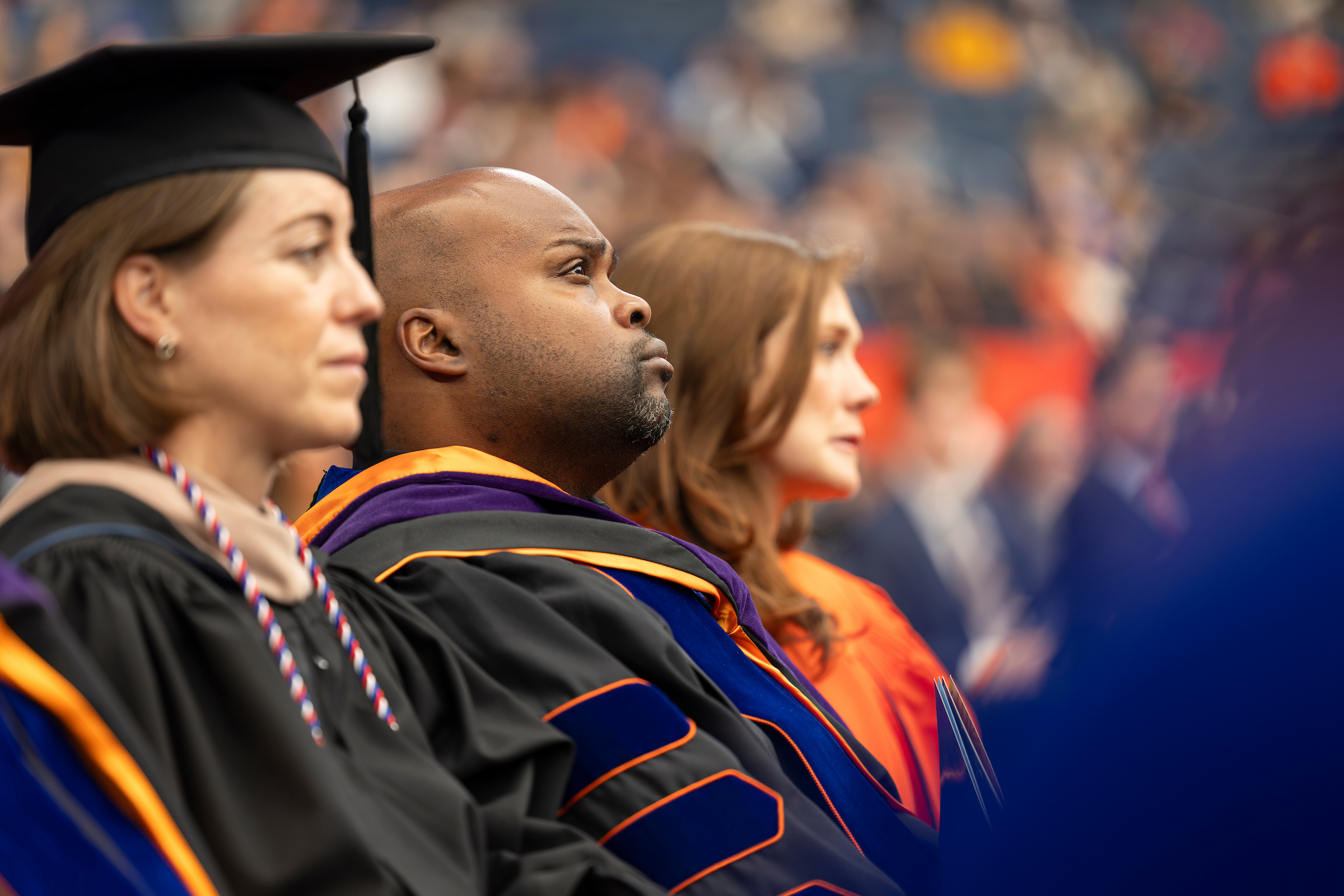 Brian Blair, the university's athletic director, listens intently during the inauguration ceremony.