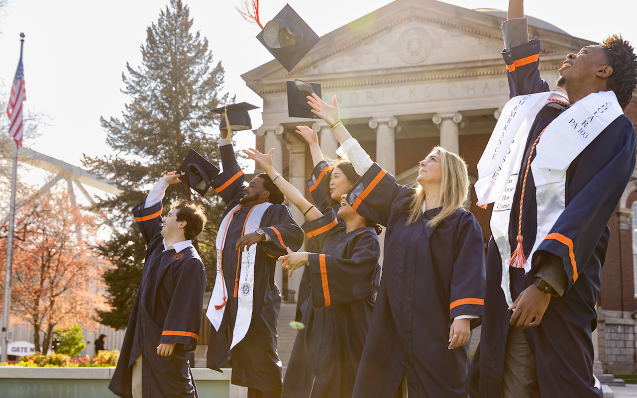 Students throwing their caps into the air
