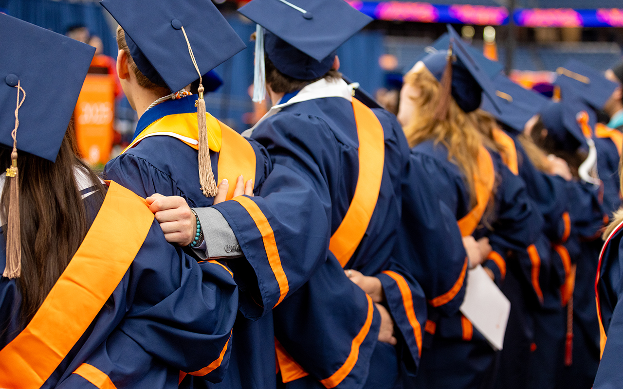 Graduates locking arms