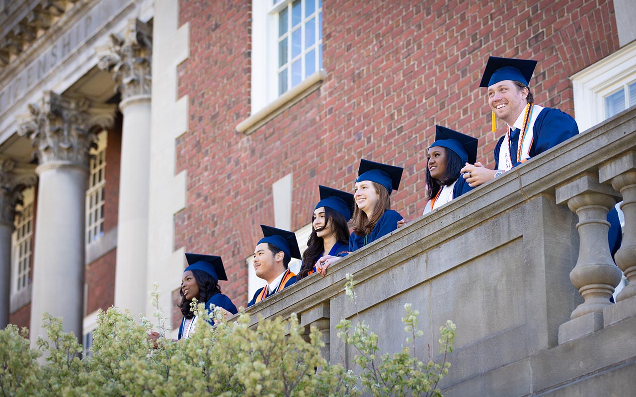 Graduates looking out over the Maxwell balcony