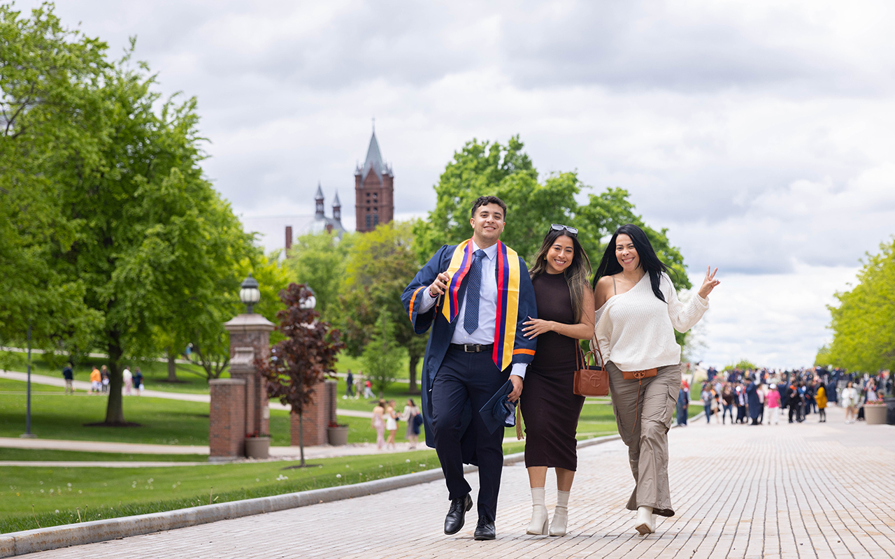 A student and his family walking on Einhorn Family Walkway