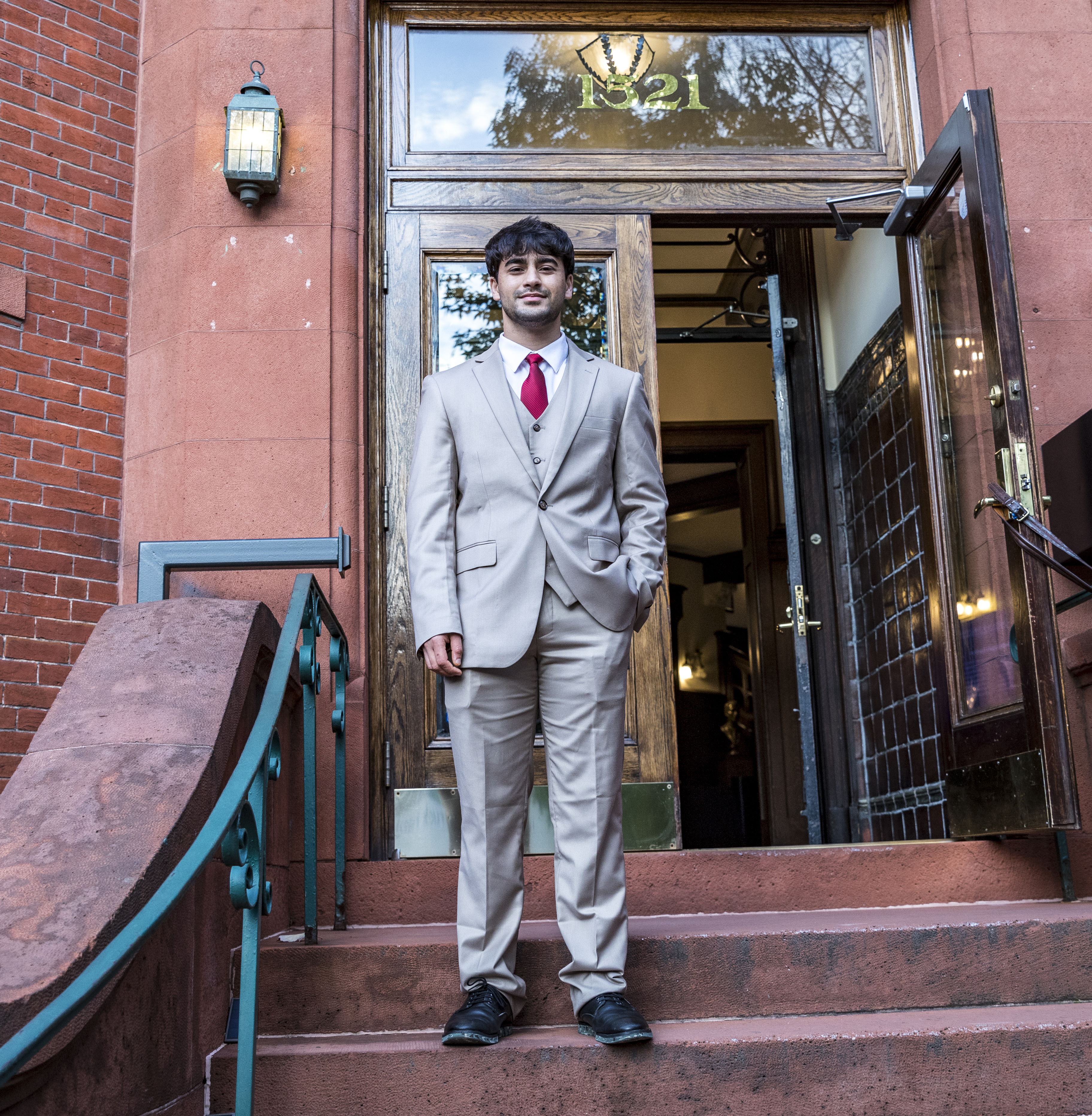 Maxwell student standing in front of building.