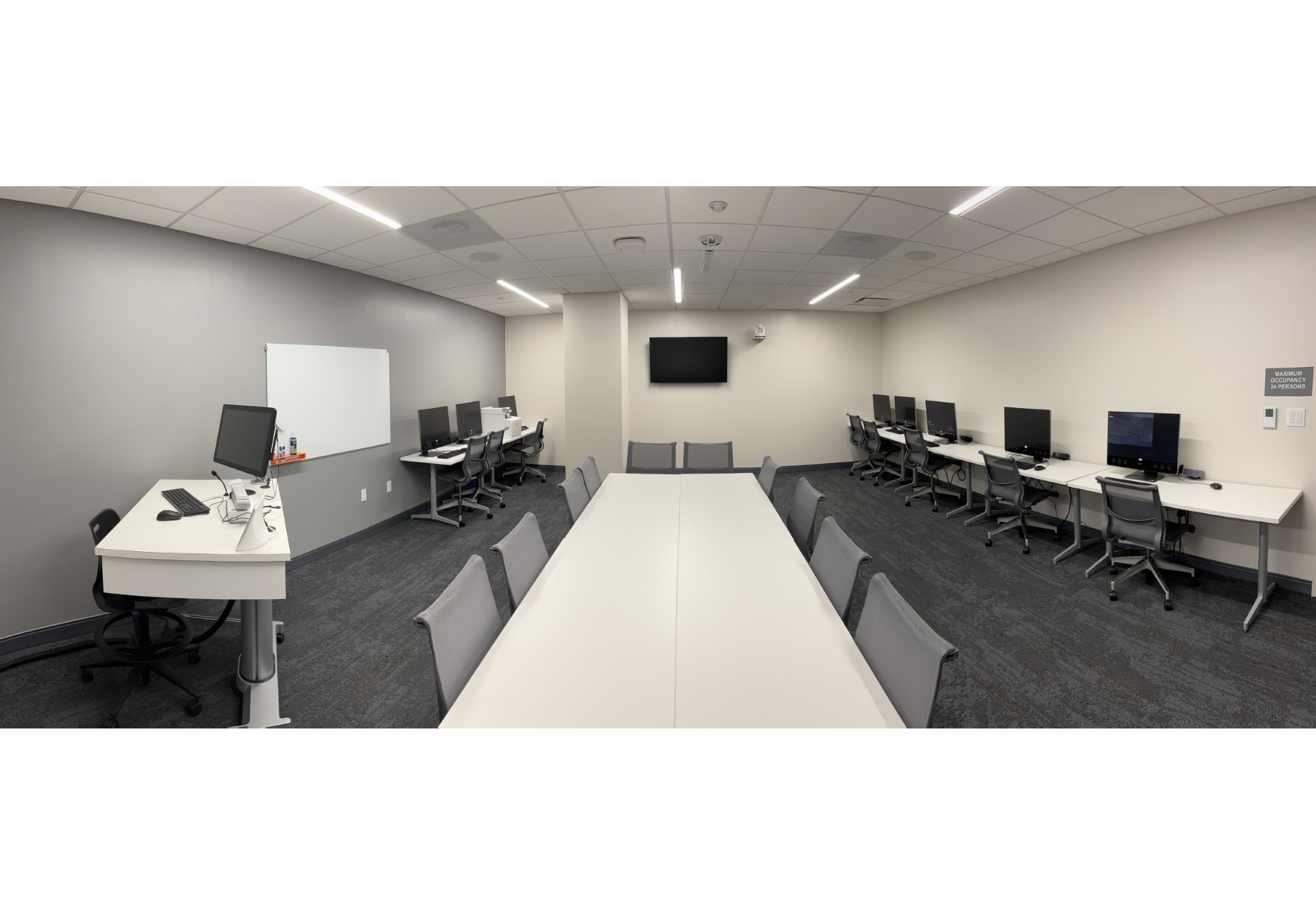 SUDC classsroom currently empty with table, chairs, and computers.