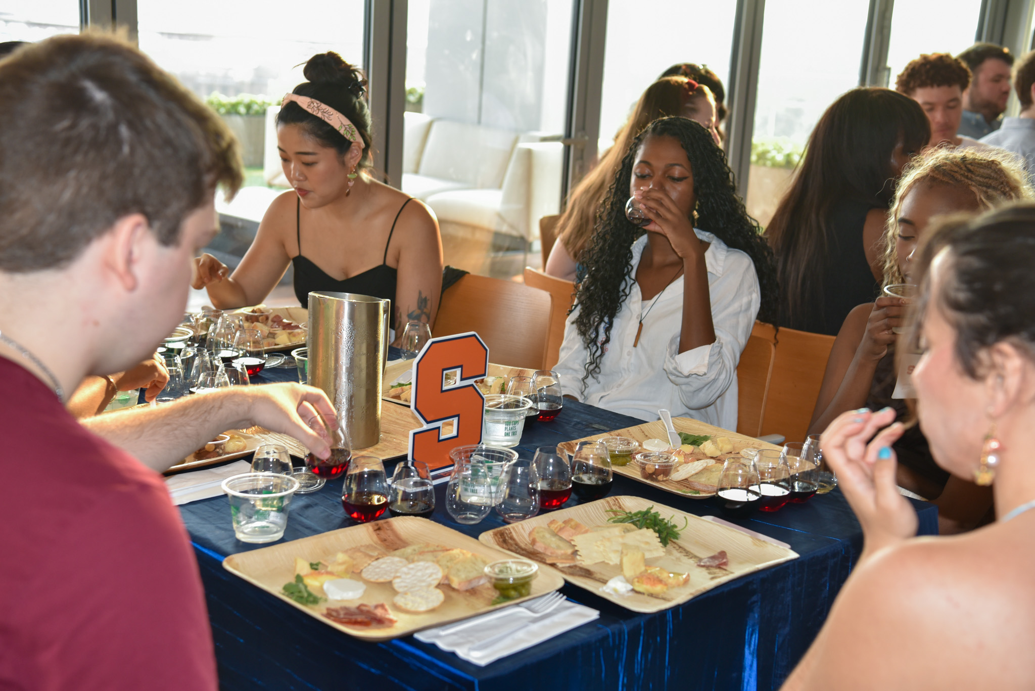 students sipping wine and tasting food. 