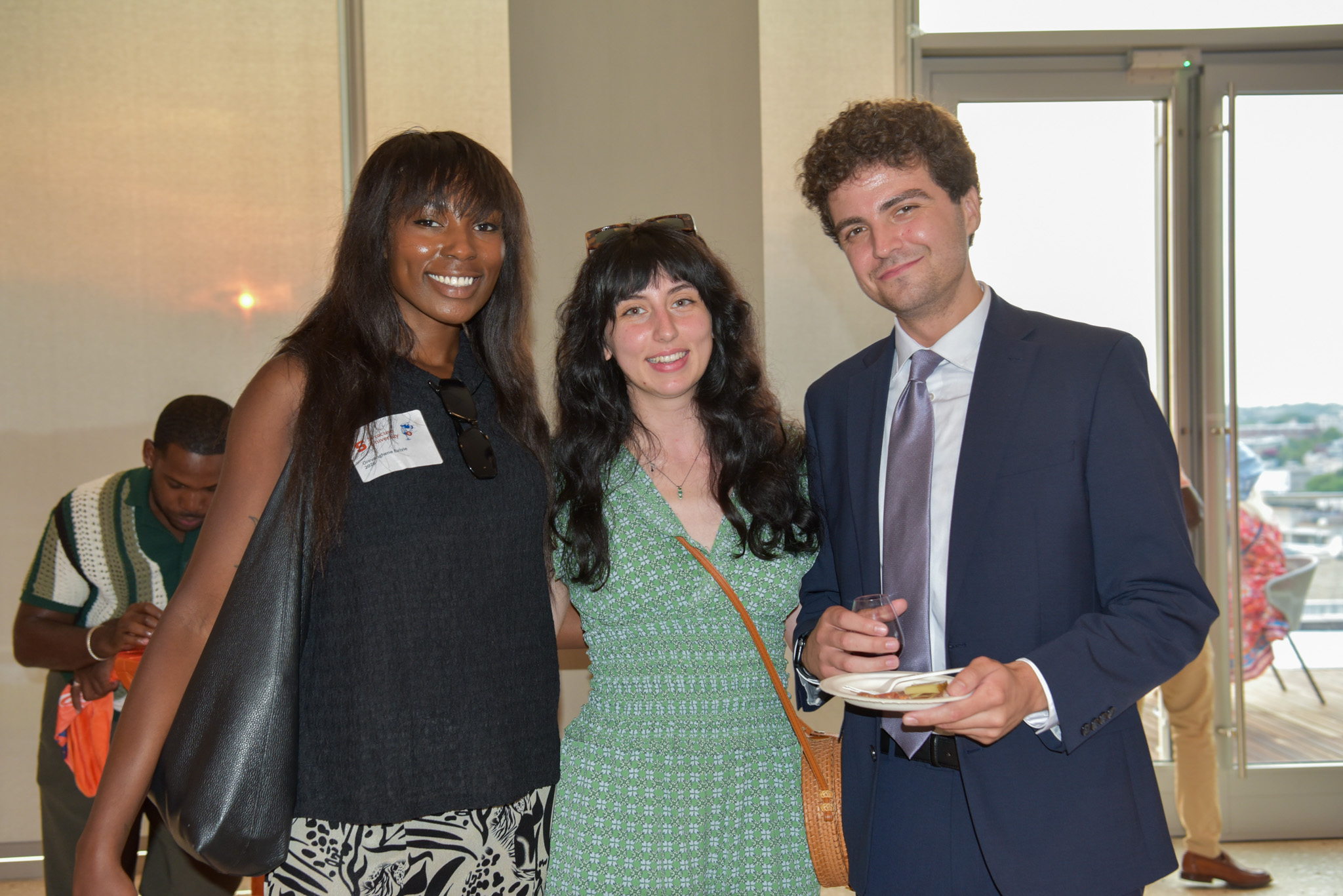 Three people posing for photo at wine appreciation.
