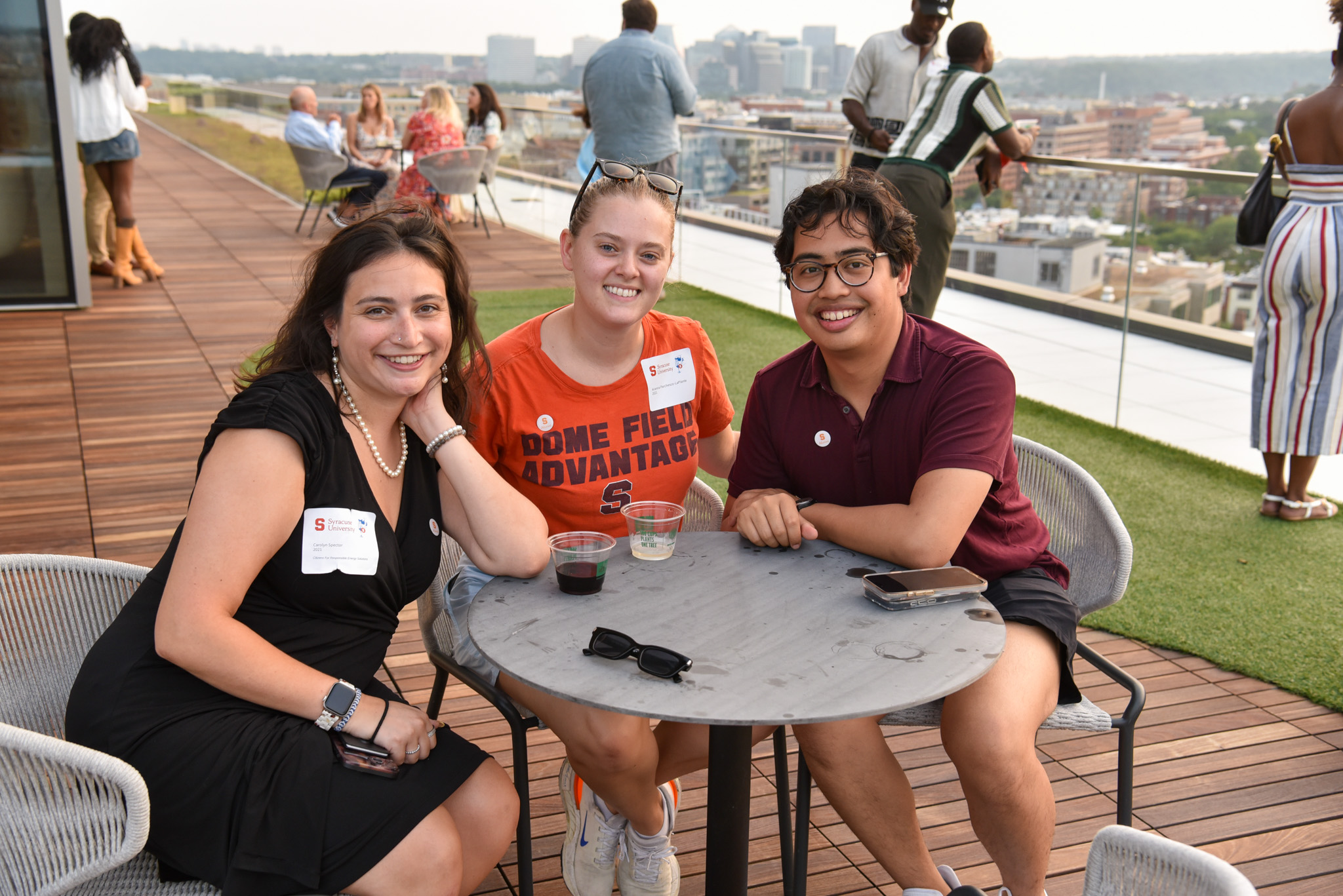 Three people at SU DC outside terrace posing for photo for wine appreciation.