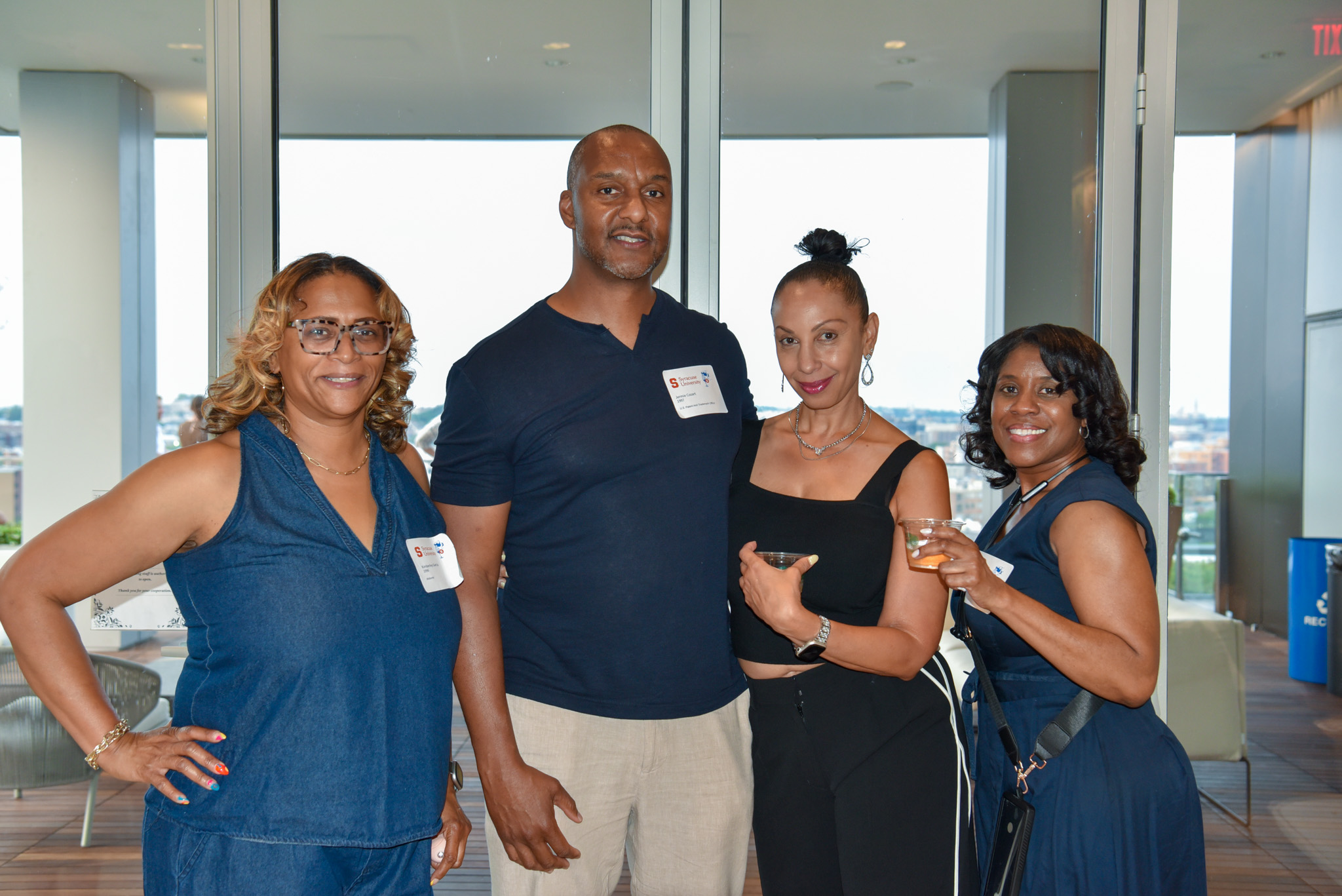 Four people posing for photo at wine appreciation in SU DC.