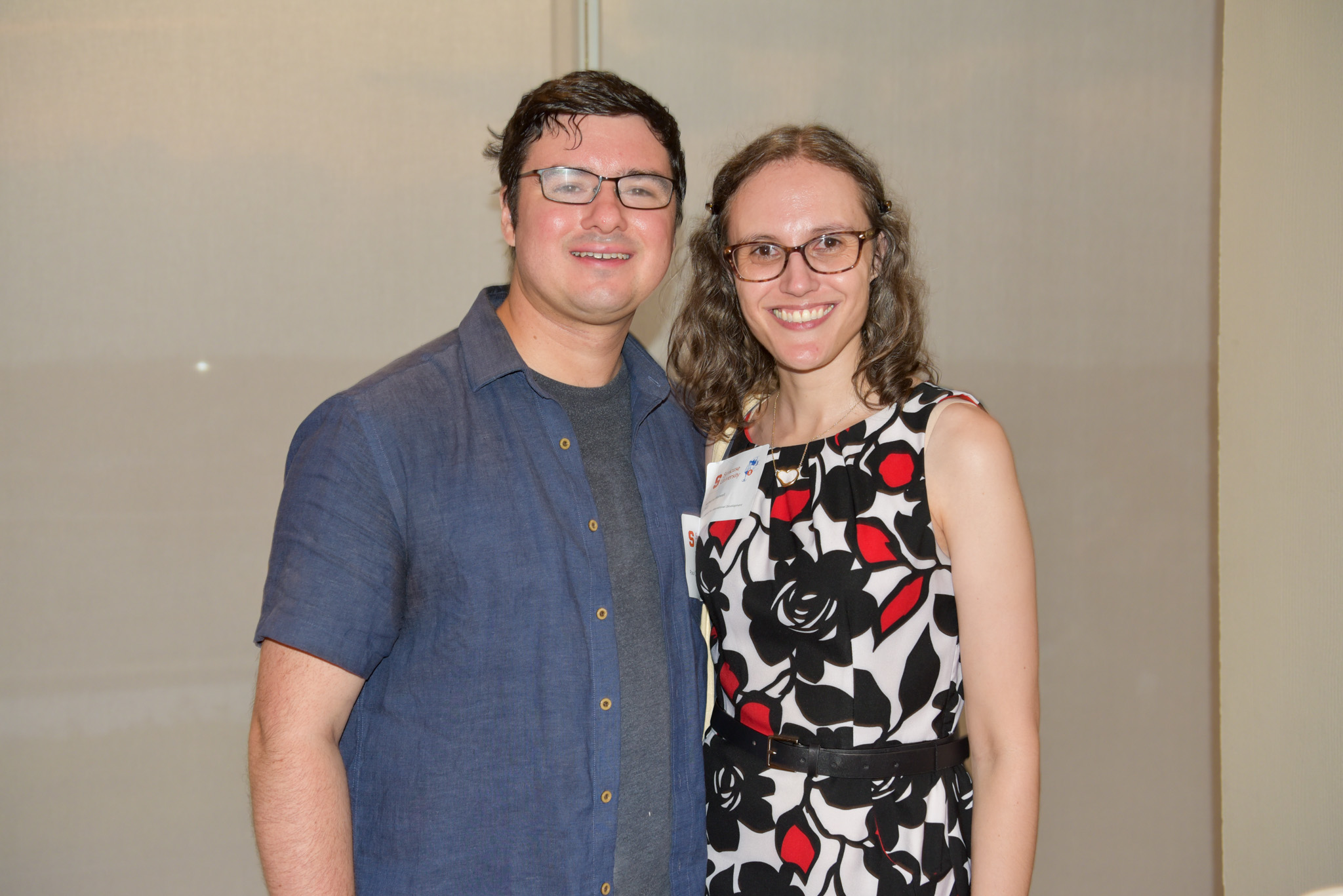 Two people posing for photo at wine appreciation in SU DC.