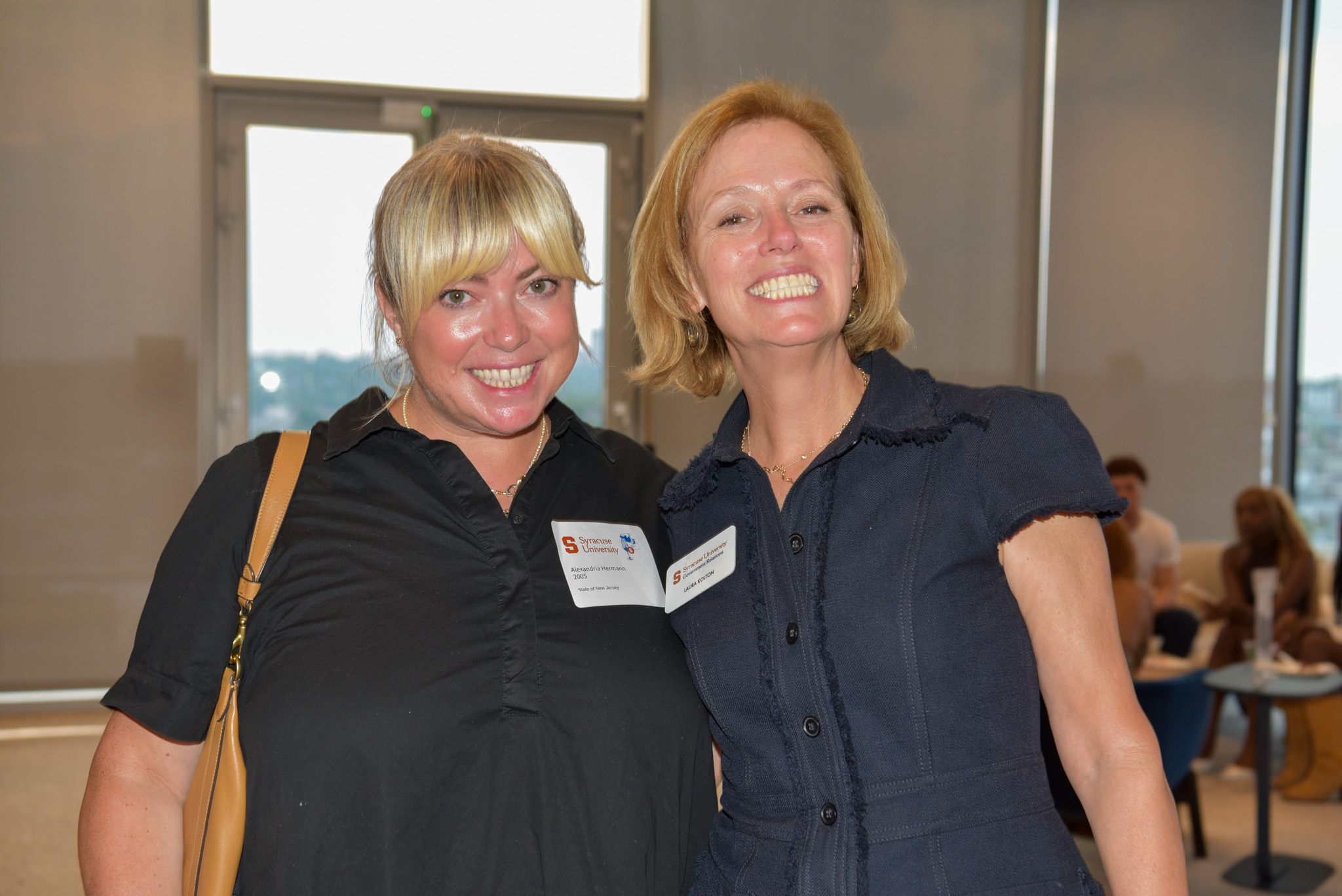 Two people posing for photo at wine appreciation in SU DC.