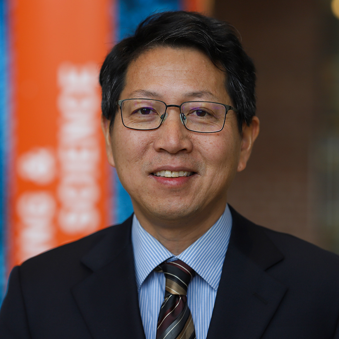 A portrait of Quinn Qiao in a suit