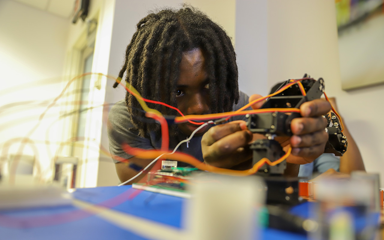 A man adjusting wires