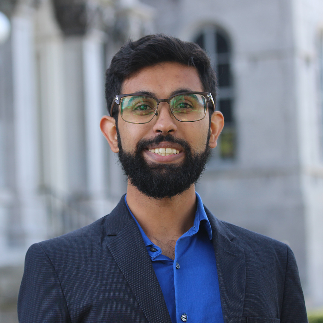 A man with a beard and glasses smiling