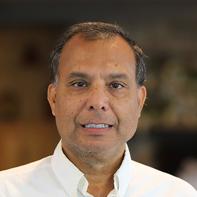 A man wearing a white Oxford shirt.