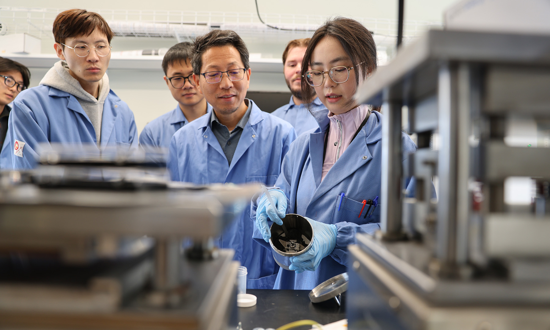Professor Quinn Qiao and his research team working on battery development