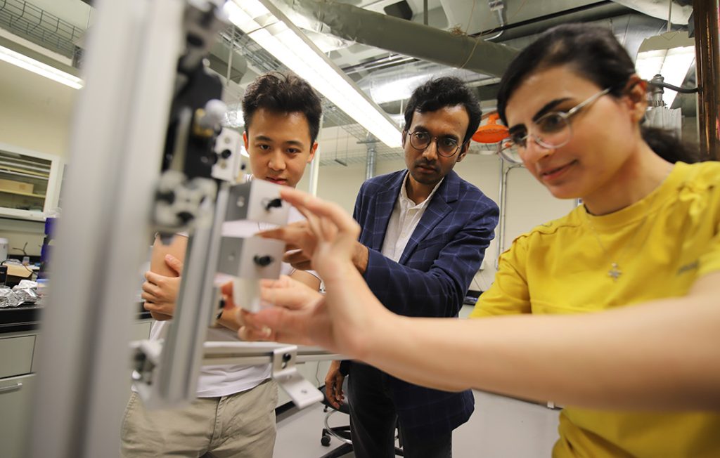 Mechanical and Aerospace Engineering Professor Anupam Pandey and two students work on a research project
