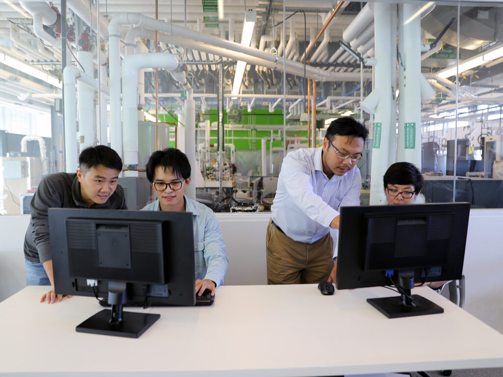 Bing Dong and students working on computers