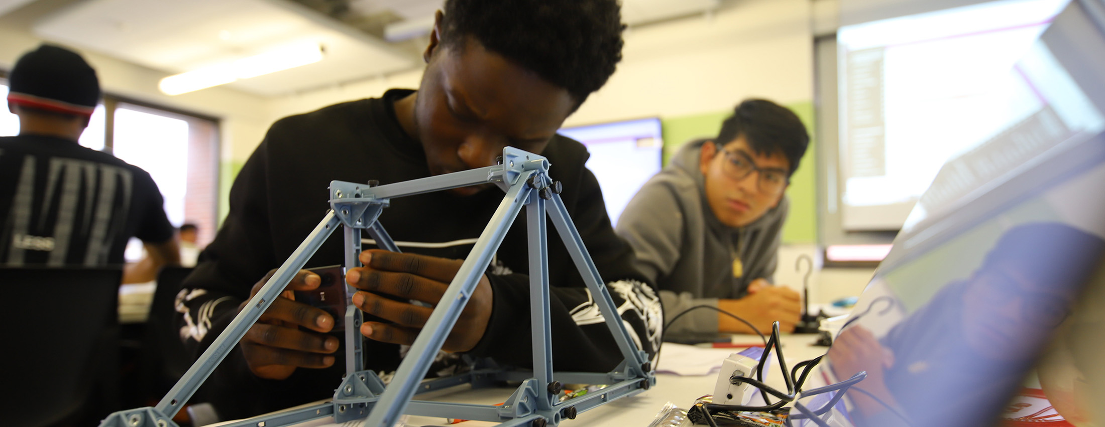 Students working on a bridge building exercise