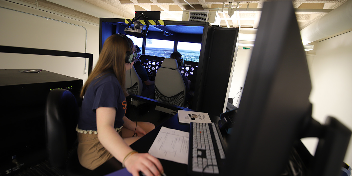 Students flying in the Syracuse University Flight Simulator