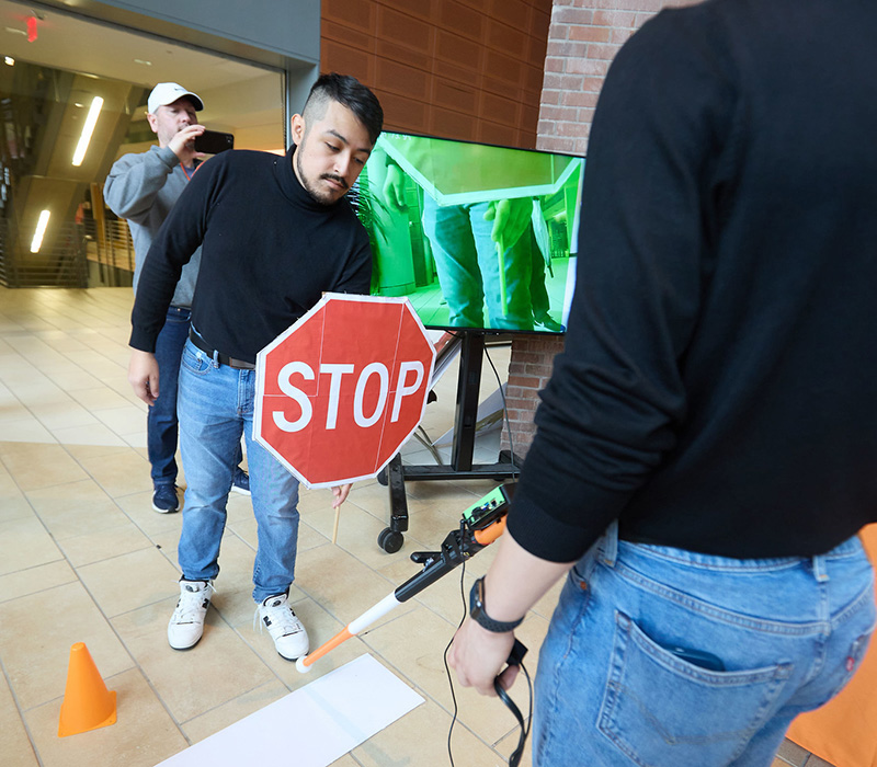 Student inventors testing a smart cane