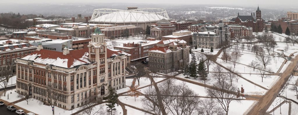 Paths crisscross a snow covered campus in December.
