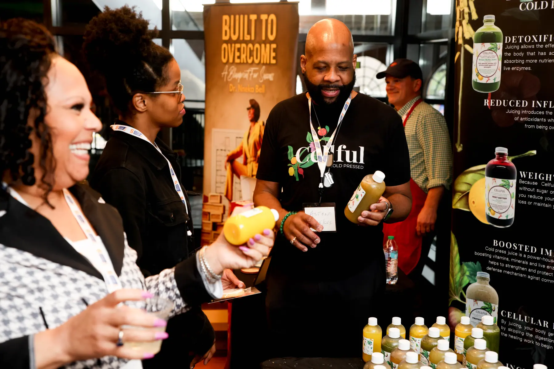 MEF NYC attendees listen to a juice vendor discuss their products.