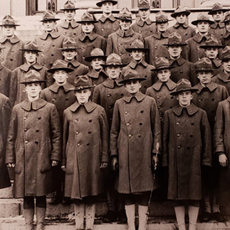 A cropped portion of a larger vintage image showing men and women in WWI uniforms standing on the SU stairway.
