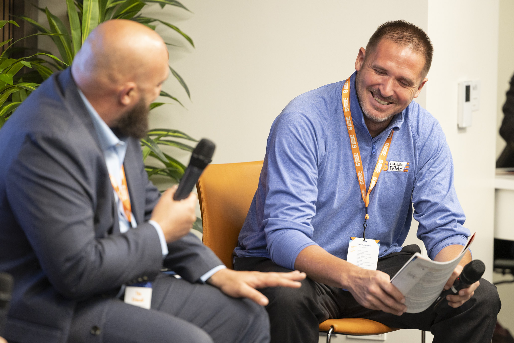 Two people laughing on a CoP panel in DC.