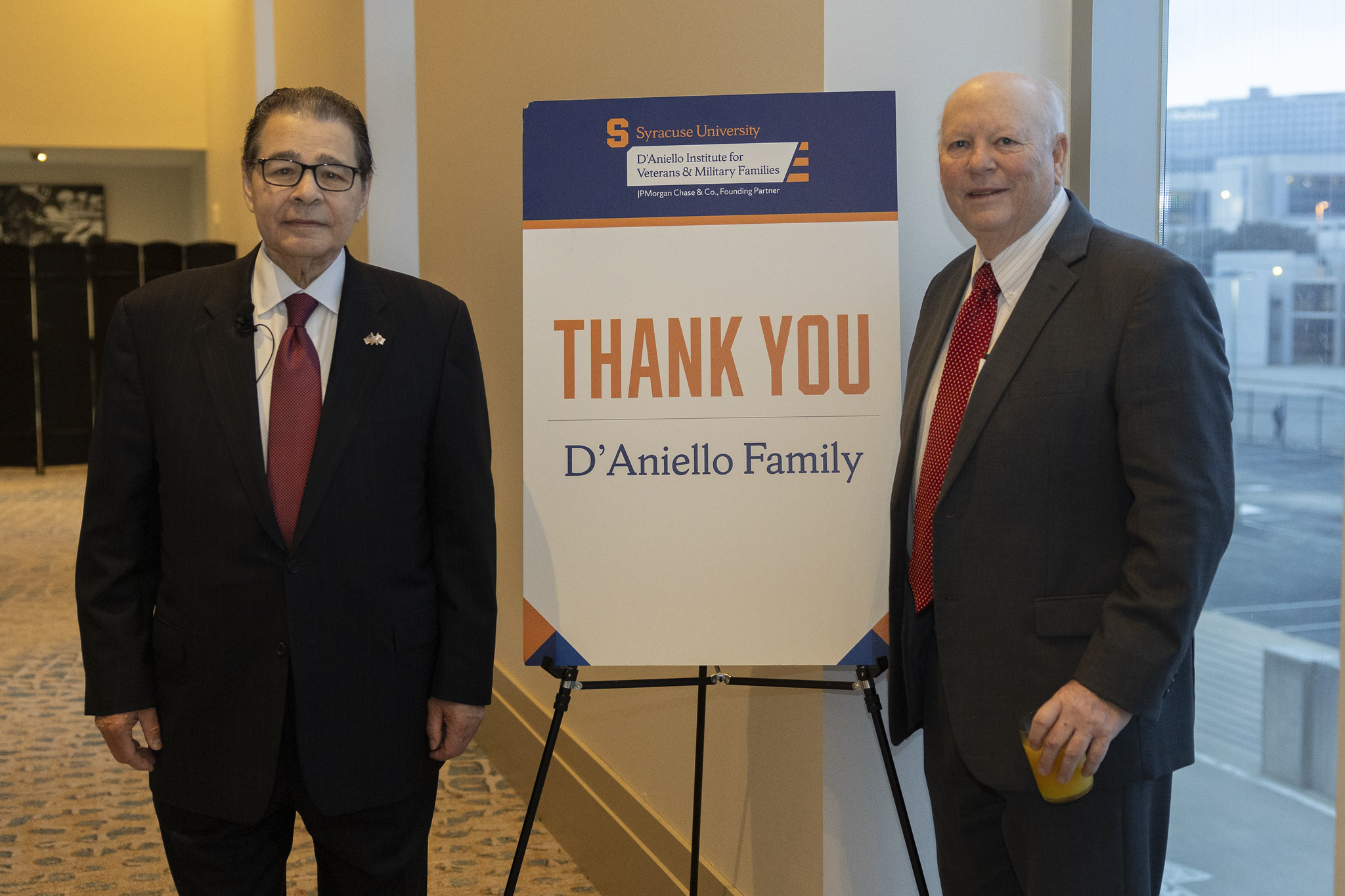 Dan D'aniello and Tom Foley posing by Thank you D'Aniello Family sign