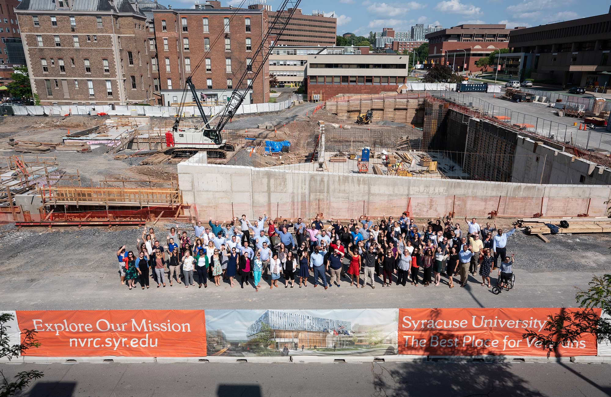 A group of people gathered in the NVRC construction site for an overhead photo