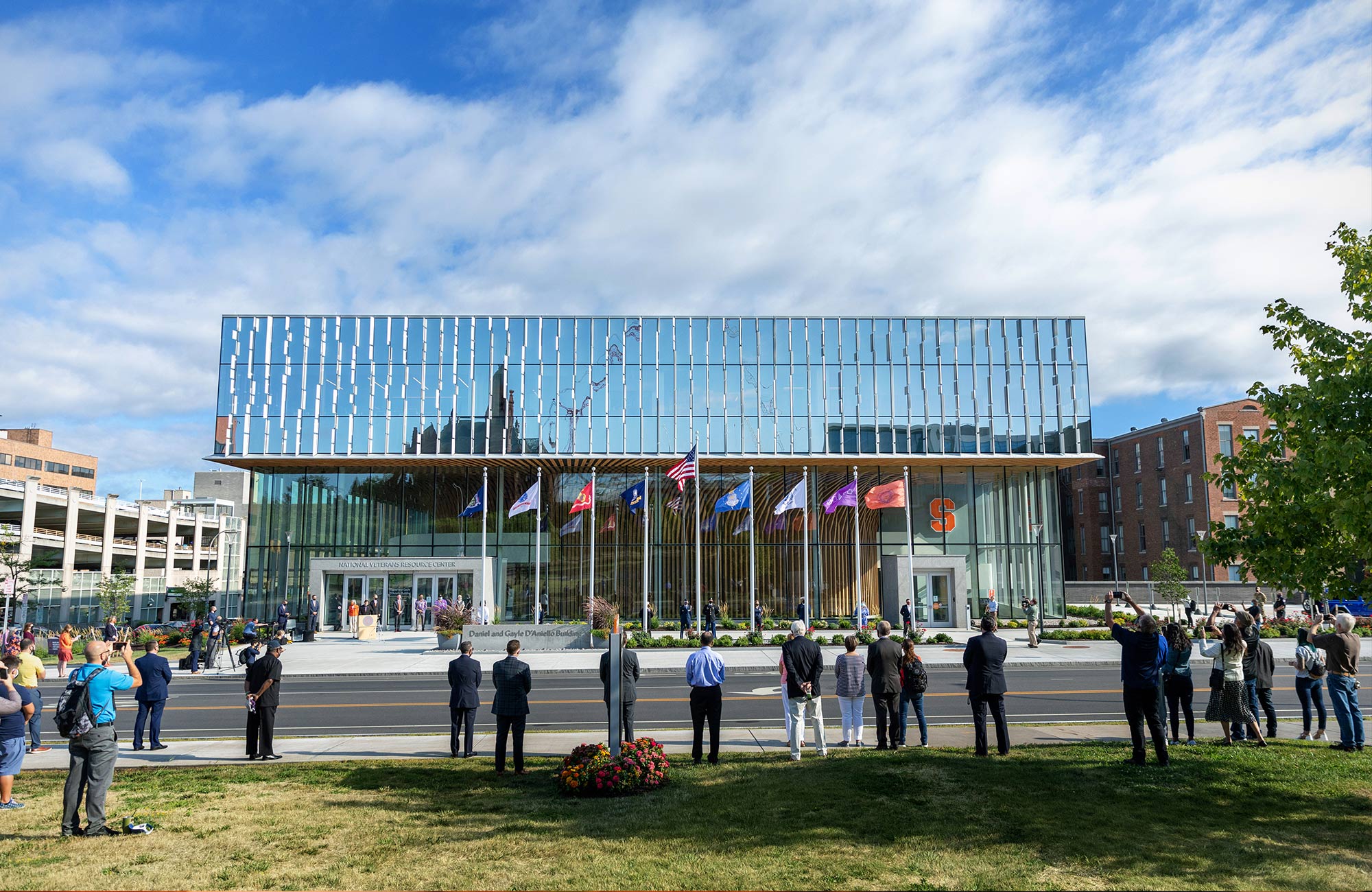 Onlookers appreciate the exterior view of the NVRC building on a sunny day
