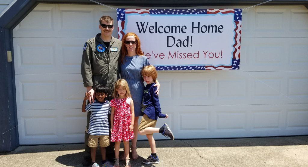 Kate johnson welcome home dad banner sign with family