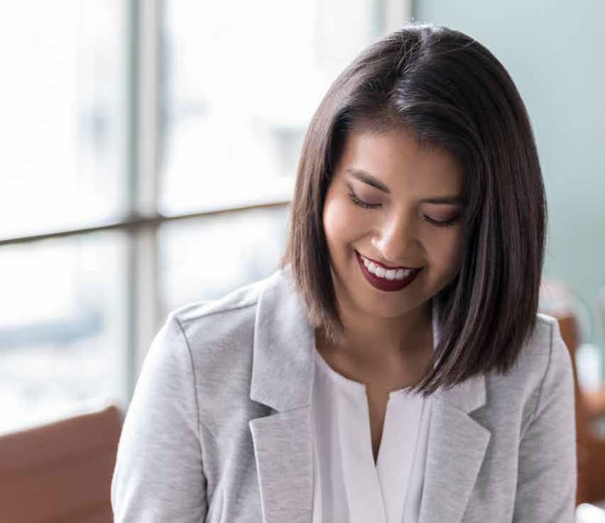Military spouse smiling and looking down.