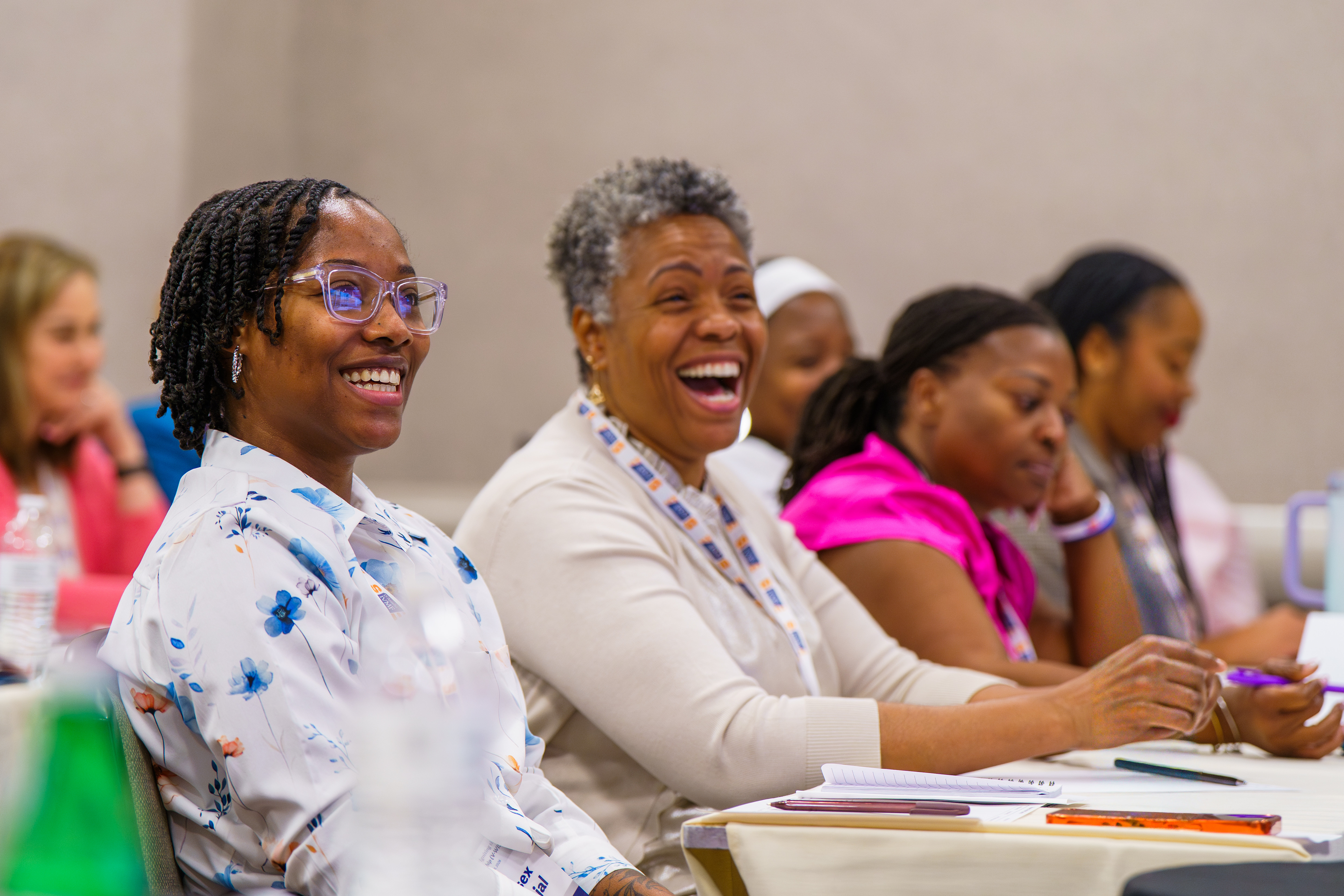 Two women smiling at V-WISE 2025.