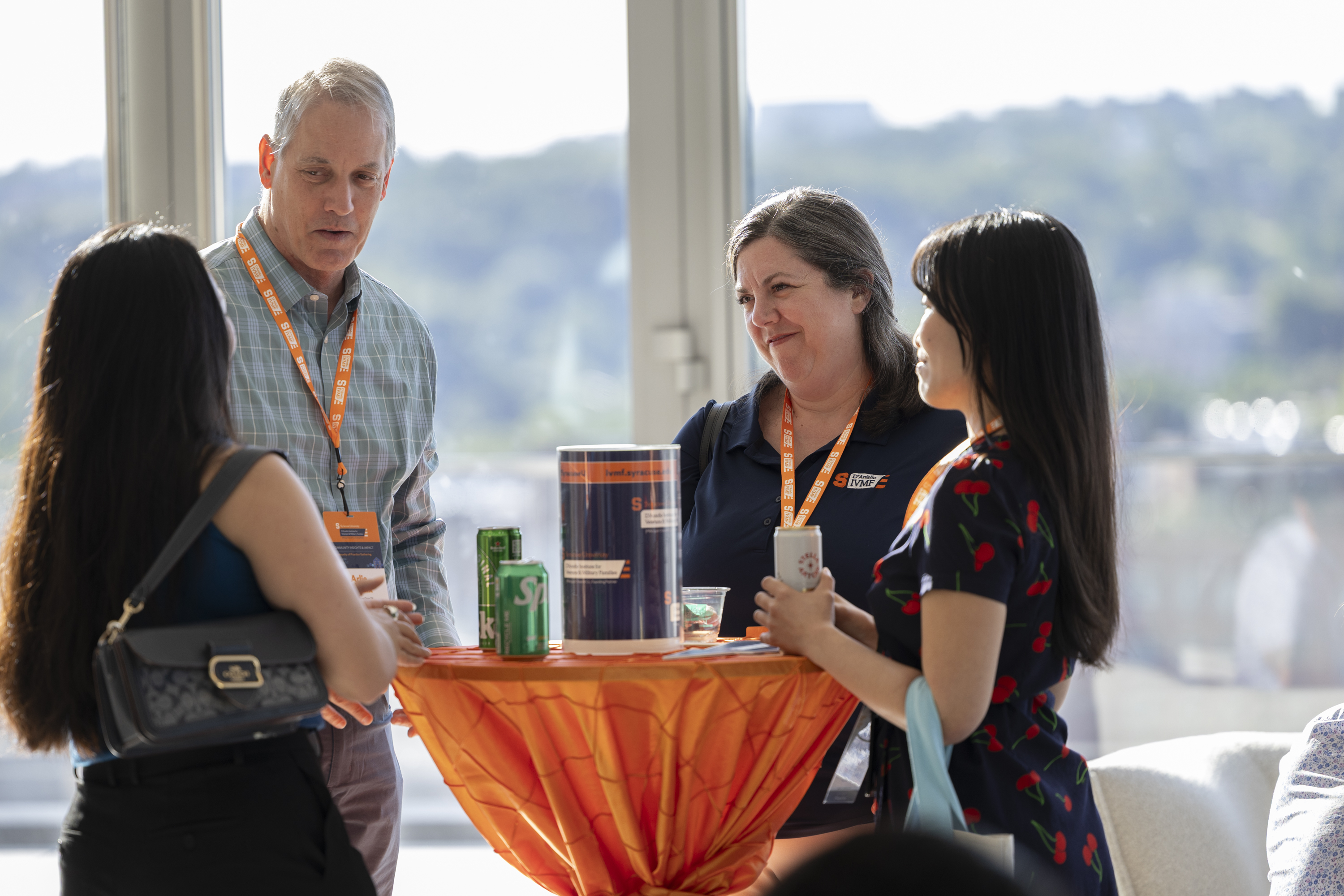 Attendees talking around a small table at CoP in DC.