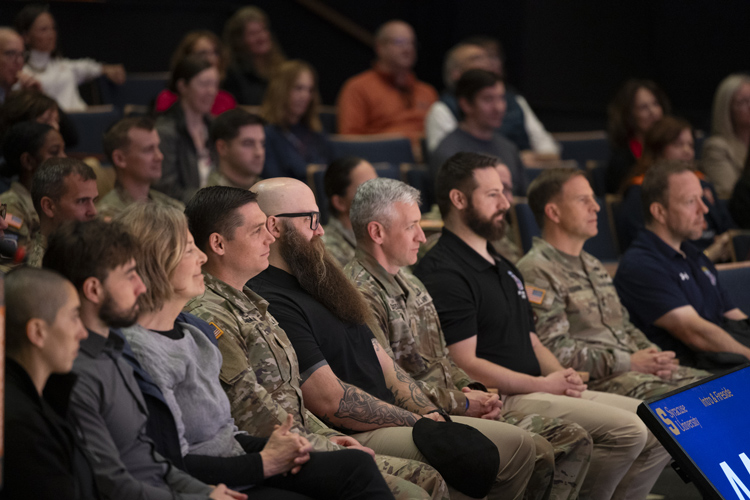 Veterans and military in the audience listening to a speaker.