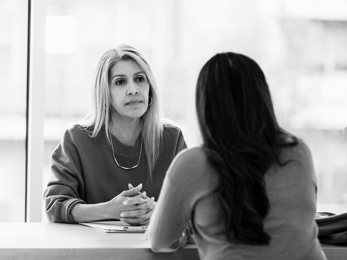 Two women in meeting representing interview.