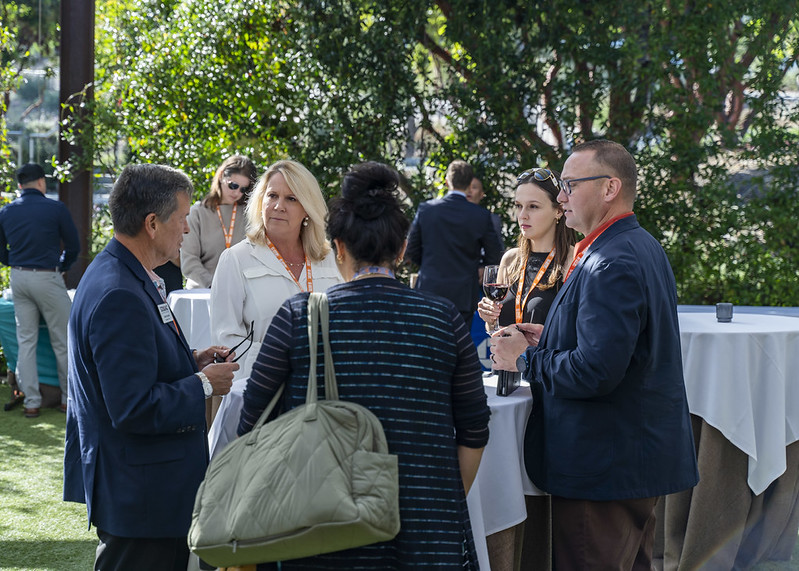 Event participants networking outside.