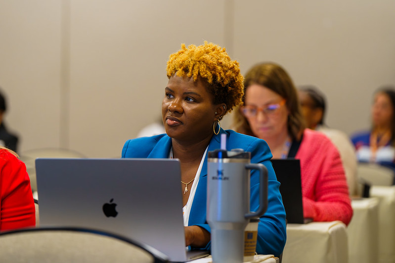VWISE participant listening to speaker over her laptop.