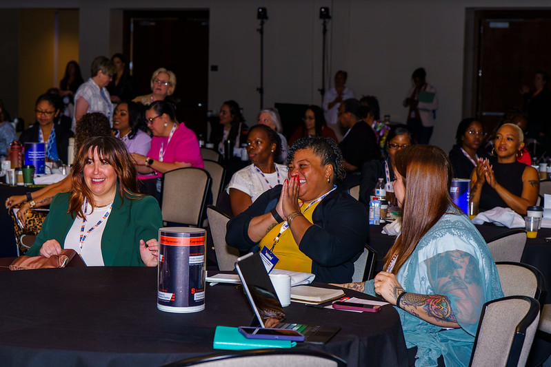 Participants at V-WISE atlanta 2026 clapping and laughing.
