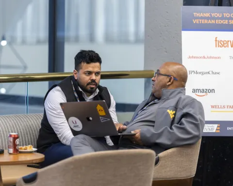 Two participants at Veteran EDGE discussing business.