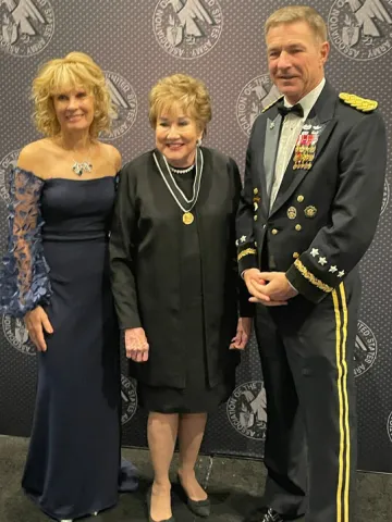 Maria McConville and her husband posing at awards. 