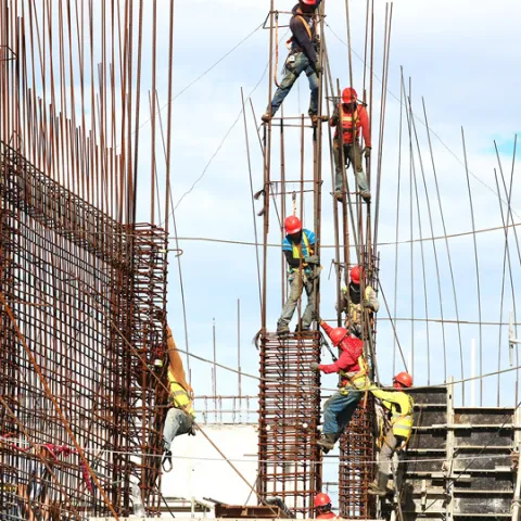 Soldiers constructing scaffolding and structure for building. 